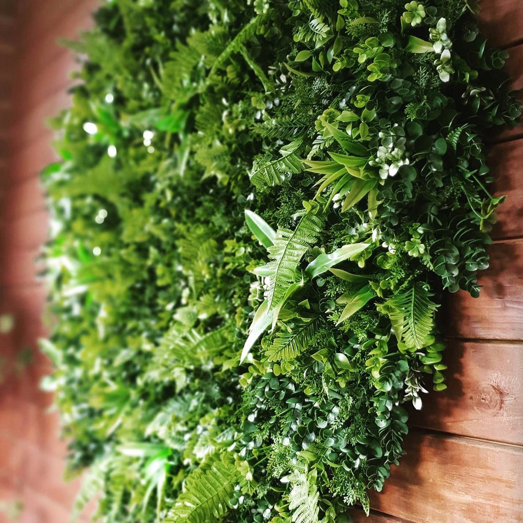 Close-up of a round artificial plant frame with mixed artificial foliage
