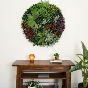 Round artificial plant frame mounted above a wooden console table